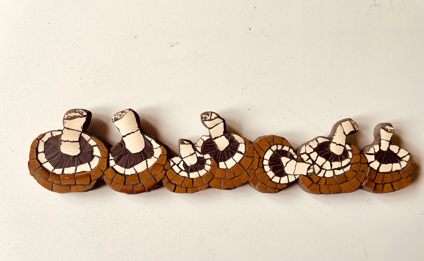 Mosaic row of mushrooms
