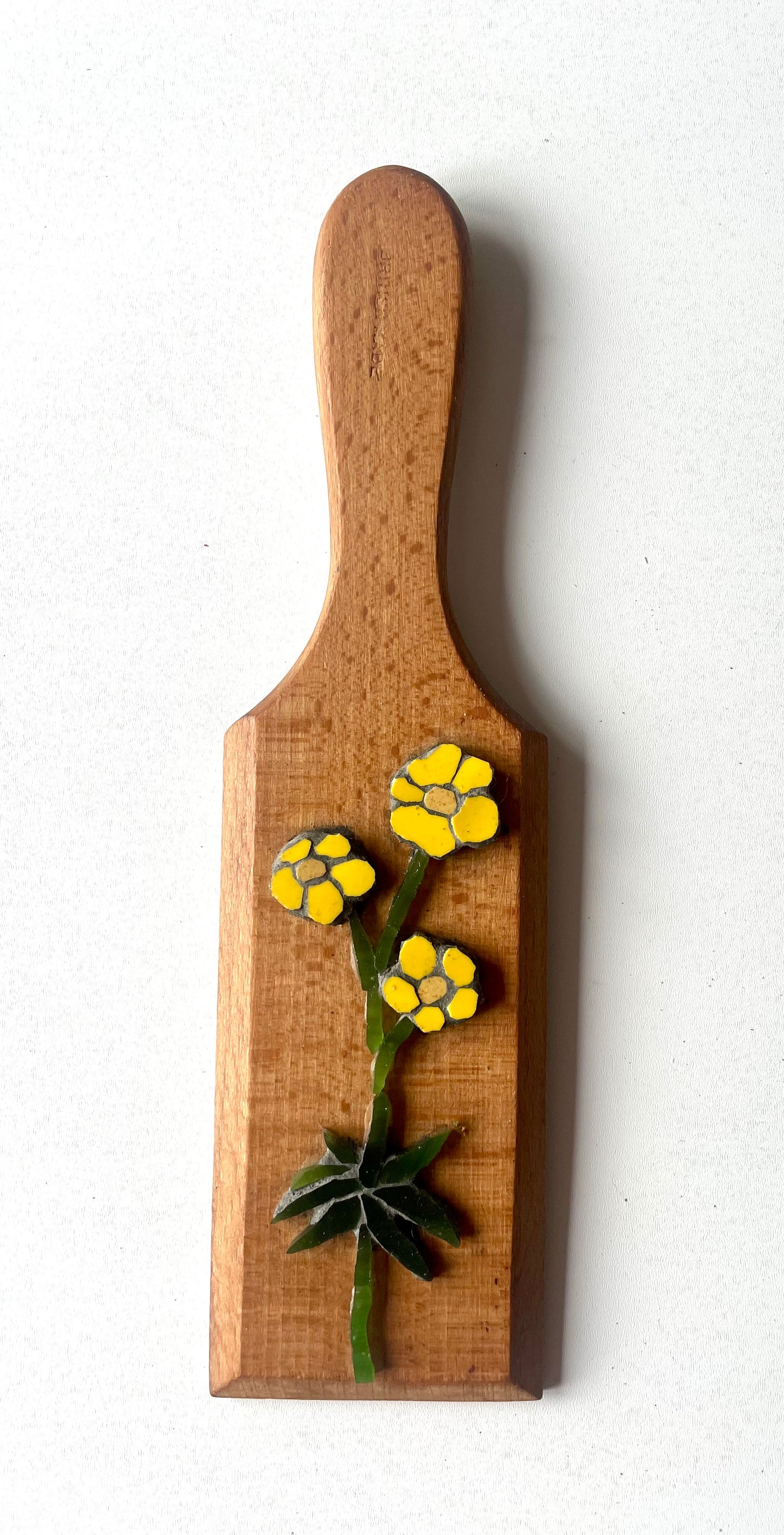 Buttercup with leaf on vintage butter pat